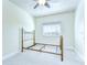This bedroom features a brass bed frame and a large window at 1134 Tracey Ann Loop, Seffner, FL 33584