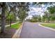 Gated community entrance with lush landscaping, mature trees, and security access point at 1134 Tracey Ann Loop, Seffner, FL 33584