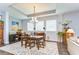 Elegant dining room with a coffered ceiling, chandelier, and a decorative area rug at 1134 Tracey Ann Loop, Seffner, FL 33584