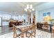 Open-concept dining area connecting to a modern kitchen with ample seating at the large island at 1134 Tracey Ann Loop, Seffner, FL 33584