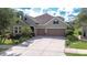 Charming two-story home with a spacious three-car garage, landscaped yard, and stone accents at 1134 Tracey Ann Loop, Seffner, FL 33584
