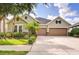 Charming home with a three-car garage, well-manicured lawn and lush landscaping at 1134 Tracey Ann Loop, Seffner, FL 33584