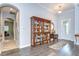 Inviting foyer showcasing hardwood floors, an arched doorway, and a stylish display cabinet at 1134 Tracey Ann Loop, Seffner, FL 33584