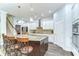 Spacious kitchen featuring a large island with seating, stainless steel appliances, and white cabinetry at 1134 Tracey Ann Loop, Seffner, FL 33584
