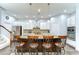 Modern kitchen showcasing an island with bar stools, stainless steel appliances, and stylish lighting at 1134 Tracey Ann Loop, Seffner, FL 33584