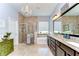The bright main bathroom has double sinks, granite countertops, a shower, and a soaking tub at 1134 Tracey Ann Loop, Seffner, FL 33584