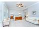 The spacious main bedroom includes a ceiling fan, large windows, and a comfortable sitting area at 1134 Tracey Ann Loop, Seffner, FL 33584