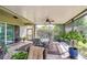 Covered patio featuring tile floors and overlooking the backyard landscaping at 1134 Tracey Ann Loop, Seffner, FL 33584