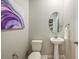 Half bathroom featuring a pedestal sink, oval mirror, and modern fixtures at 1136 Creek Valley Ct, Brandon, FL 33511
