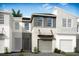 Charming townhome featuring a modern facade, attached garage, and well-manicured landscaping at 1136 Creek Valley Ct, Brandon, FL 33511
