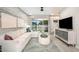 Bright living room featuring a white sofa, modern decor, and a sliding glass door at 1136 Creek Valley Ct, Brandon, FL 33511