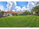 Expansive backyard featuring a lush lawn, tropical landscaping, and ample space for outdoor activities at 11624 Bristol Chase Dr, Tampa, FL 33626