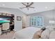 Bright bedroom with a ceiling fan, a closet and built-in desk, and a window with plantation shutters at 11624 Bristol Chase Dr, Tampa, FL 33626