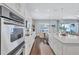 Gourmet kitchen with a large center island, stainless appliances, and hardwood floors at 11624 Bristol Chase Dr, Tampa, FL 33626