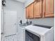 This laundry room features a front load washer and dryer, tile floor, and cabinets at 11624 Bristol Chase Dr, Tampa, FL 33626