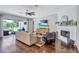Comfortable living room with hardwood floors, recessed lighting, fireplace, and TV at 11624 Bristol Chase Dr, Tampa, FL 33626