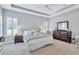 This main bedroom features an accent wall, plush carpet, and dark wood furniture at 11624 Bristol Chase Dr, Tampa, FL 33626
