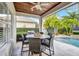 Inviting outdoor patio featuring a dining table with seating, and a beautiful view of the pool and lush landscaping at 11624 Bristol Chase Dr, Tampa, FL 33626