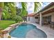 Beautiful pool with spa, waterfall feature, and a covered patio offering an ideal outdoor living and entertaining space at 11624 Bristol Chase Dr, Tampa, FL 33626