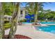 Fun swimming pool area with a water slide, comfortable lounge chairs, and tropical landscaping at 11624 Bristol Chase Dr, Tampa, FL 33626