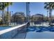 Community tennis court with covered benches, well-maintained surfaces, and lush palm tree surroundings at 11624 Bristol Chase Dr, Tampa, FL 33626