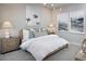 Comfortable bedroom with a soft color palette, stylish lighting, and decorative artwork at 11830 Boundless Ter, Venice, FL 34293