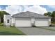 Charming new construction home showcasing a two-car garage and well-manicured lawn at 11830 Boundless Ter, Venice, FL 34293