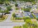 Areal of the home showing lush landscaping, a screened pool, and a corner lot in a quiet neighborhood at 12062 Stone Crossing Cir, Tampa, FL 33635