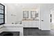 Bright bathroom featuring double sinks, granite countertops, and a separate tub area at 12062 Stone Crossing Cir, Tampa, FL 33635