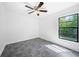 Bedroom features a ceiling fan and a large window providing natural light and exterior views at 12062 Stone Crossing Cir, Tampa, FL 33635