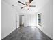 Bright bedroom with gray tile, closet, a ceiling fan, and natural light streaming through the window at 12062 Stone Crossing Cir, Tampa, FL 33635