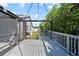 Gray wooden deck view looking towards the backyard with green grass at 12062 Stone Crossing Cir, Tampa, FL 33635