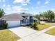 Well-manicured front yard with a long driveway leading to a two-car garage at 12062 Stone Crossing Cir, Tampa, FL 33635