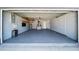 View of the interior of the spacious 2-car garage with overhead lighting at 12062 Stone Crossing Cir, Tampa, FL 33635