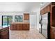 Bright kitchen with stainless steel appliances, granite counters, and view of the backyard pool at 12062 Stone Crossing Cir, Tampa, FL 33635