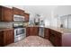 Updated kitchen with stainless steel appliances, granite counters, and easy access to living spaces at 12062 Stone Crossing Cir, Tampa, FL 33635