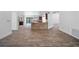 Open-concept living room with tile floors flows seamlessly into the kitchen and outdoor living spaces at 12062 Stone Crossing Cir, Tampa, FL 33635