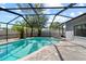 Sparkling screened-in pool and spa offer a relaxing outdoor retreat with beautiful stone pavers at 12062 Stone Crossing Cir, Tampa, FL 33635