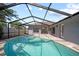 Inviting screened-in pool area with a refreshing pool and patio, perfect for outdoor relaxation and entertaining at 12062 Stone Crossing Cir, Tampa, FL 33635