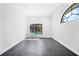 Neutral room with black slate floors and large window offering bright light at 12062 Stone Crossing Cir, Tampa, FL 33635