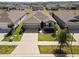 This aerial view showcases the home's well-manicured front lawn and inviting facade at 13227 Waterleaf Garden Cir, Riverview, FL 33579