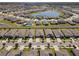 This aerial view highlights a beautiful community with a central lake at 13227 Waterleaf Garden Cir, Riverview, FL 33579