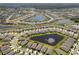 Community aerial view showcases the neighborhood's layout, lakes, and green spaces at 13227 Waterleaf Garden Cir, Riverview, FL 33579