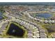An aerial view showcasing a beautiful Primary-planned community with lakes and manicured landscaping at 13227 Waterleaf Garden Cir, Riverview, FL 33579