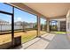 Relax on this screened patio with a view of the backyard and neighboring houses at 13227 Waterleaf Garden Cir, Riverview, FL 33579