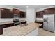 Spacious kitchen features granite countertops, stainless steel appliances, and ample cabinet space at 13227 Waterleaf Garden Cir, Riverview, FL 33579
