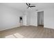 A spacious bedroom with wood-look floors includes multiple doorways for easy access throughout the home at 13227 Waterleaf Garden Cir, Riverview, FL 33579