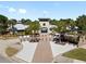 Community clubhouse with manicured landscaping, mature palms, and ample parking. Great for gatherings at 13227 Waterleaf Garden Cir, Riverview, FL 33579
