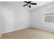 Minimalist bedroom featuring neutral walls, wood-look flooring, a ceiling fan and a window with blinds at 13227 Waterleaf Garden Cir, Riverview, FL 33579