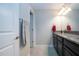 Well-lit bathroom with a granite countertop, dark cabinets, and ceramic tile flooring at 13651 Ashlar Slate Pl, Riverview, FL 33579